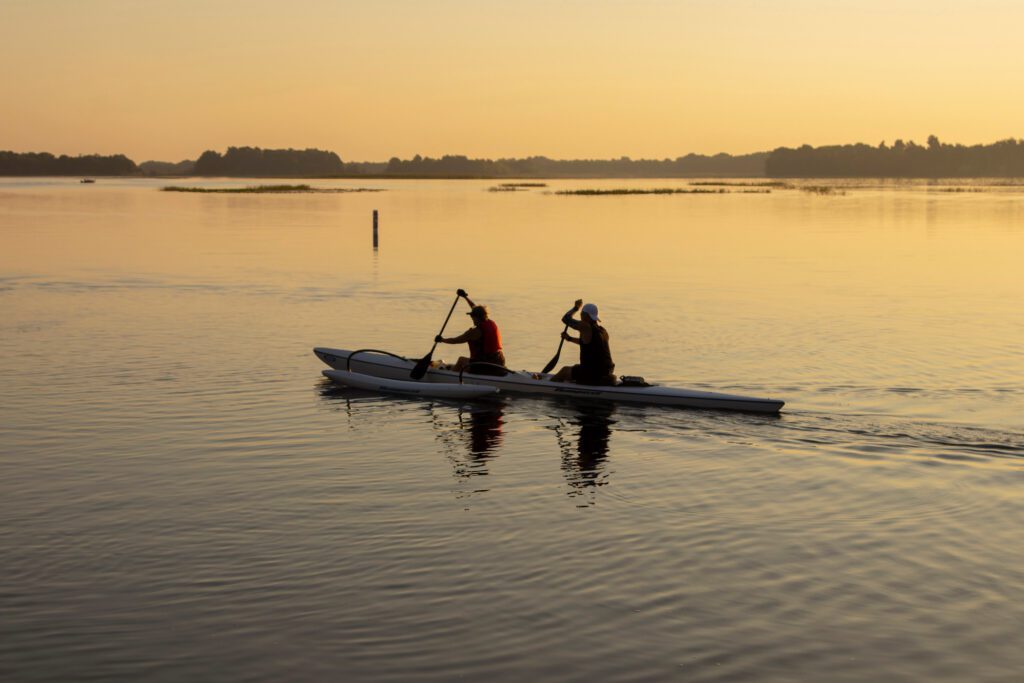 two men paddling outrigger canoe