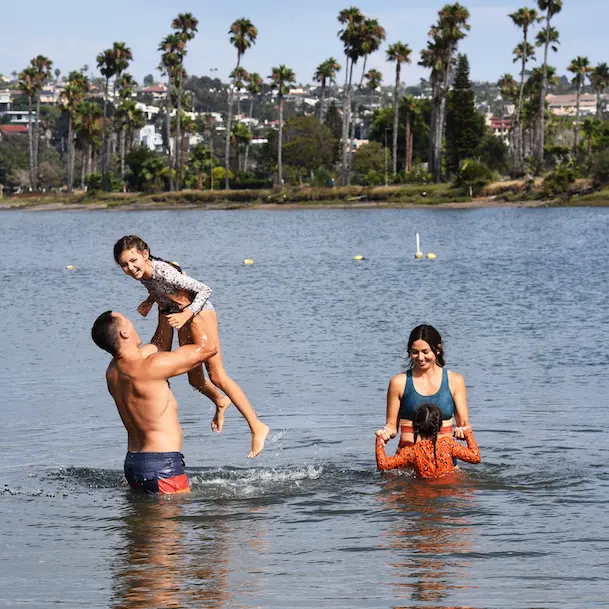 family playing in the water at De Anza Cove