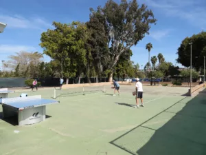 People playing pickleball on an outdoor court at Mission Bay RV Resort