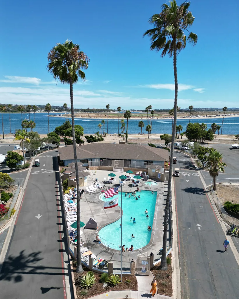 swimming pool, spa and clubhouse along the water at Mission Bay RV Resort